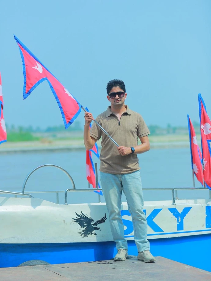 Milan Baral with a national flag of nepal